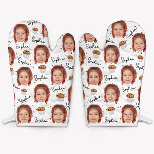 A pair of white oven mitts customized with a photo and the name 'Sophia' printed repeatedly.