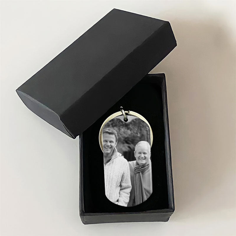 Two stainless steel keychains, one with a black and white photo of a smiling man and woman, and the other with an engraved message and the name 'Pop Pop' along with dates.