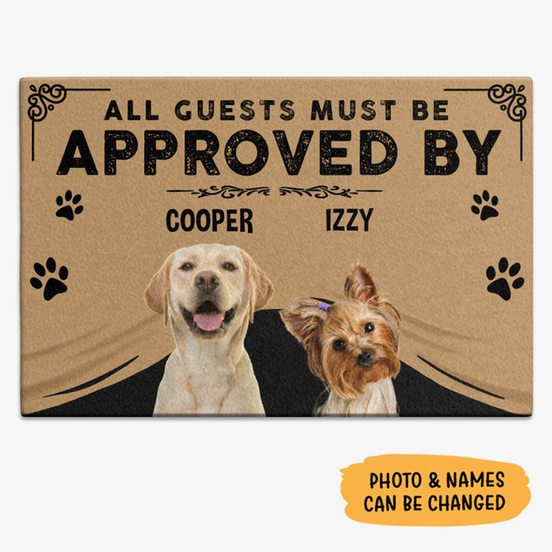 Customized doormat with the text 'All guests must be approved by' followed by two dog names 'Cooper' and 'Izzy', along with images of two dogs, a golden retriever and a yorkshire terrier, on a front porch.